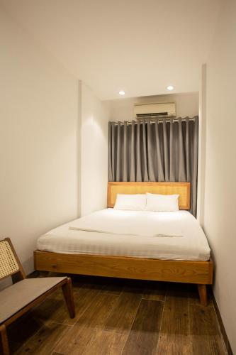 a bedroom with a large bed with a window at Lanha Hotel - Homestay in Hanoi