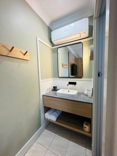 a bathroom with a sink and a mirror at Royal Hotel-Motel in Moree