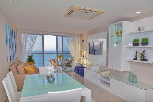 a living room with a table and a dining room at Luxury Beachfront Apartment - Morros City in Cartagena de Indias