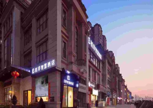 a building with signs on the side of a street at Luzhou Baian Smart Hotel in Luzhou