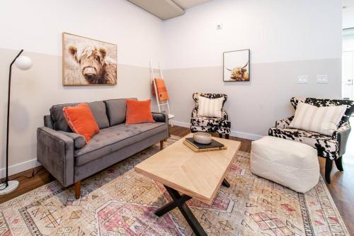 a living room with a couch and a table at Modern Country Retreat-5 min to DTN-U/G Parking in Edmonton