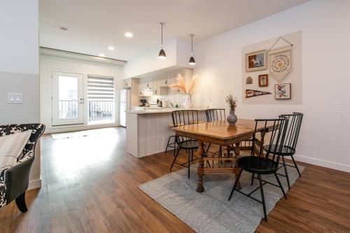 a dining room and kitchen with a table and chairs at Modern Country Retreat-5 min to DTN-U/G Parking in Edmonton