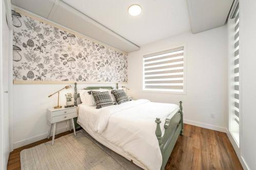 a white bedroom with a bed and a window at Modern Country Retreat-5 min to DTN-U/G Parking in Edmonton