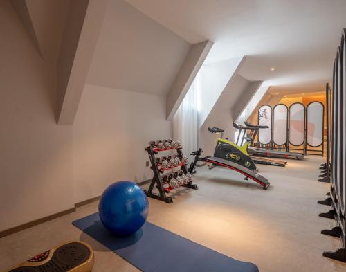 a gym with a blue ball in the middle of a room at Luzhou Baian Smart Hotel in Luzhou