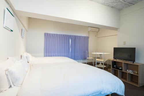 Una cama o camas en una habitación de Nagai park side stay