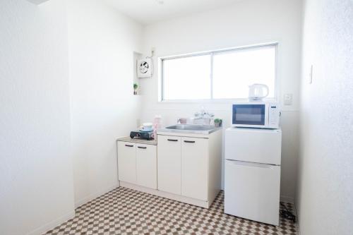Una cocina o cocineta en Nagai park side stay