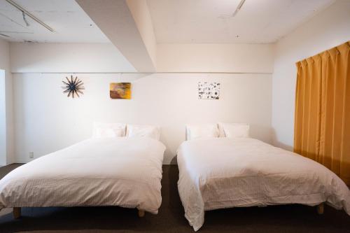 Una cama o camas en una habitación de Nagai park side stay