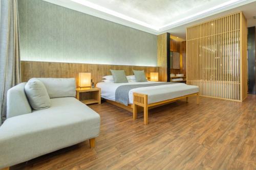 a hotel room with a bed and a couch at Lin Yin Art Hotel Shanghai（Pudong airport） in Shanghai