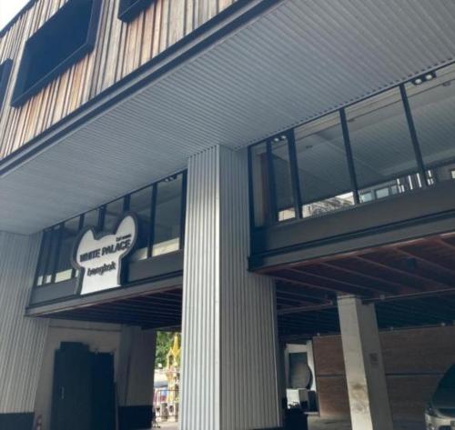 a building with a sign on the side of it at White Palace Bangkok in Bangkok