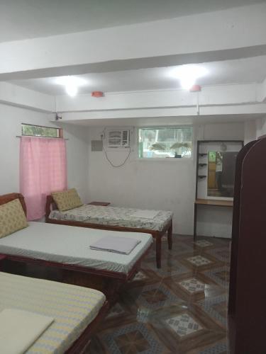a room with couches and tables in a room at Czar's Place in Siquijor