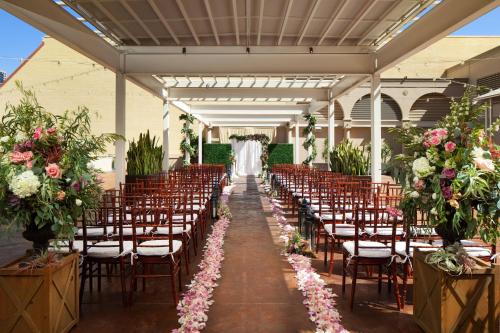 a bride and groom walking down the aisle at a wedding ceremony at The Westin San Diego Gaslamp Quarter in San Diego