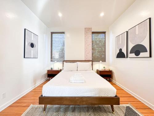 a bedroom with a bed and two windows at 3BR Stylish Residence in Los Angeles - OL in Los Angeles