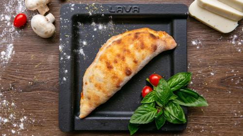 a plate with a piece of food on a table with vegetables at Amari Pattaya in Pattaya Central
