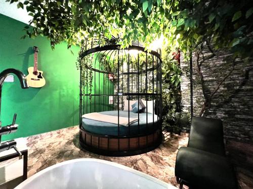 a bathroom with a bird cage with a bed in it at Loove Hotel - Khách Sạn Tình Yêu in Ho Chi Minh City