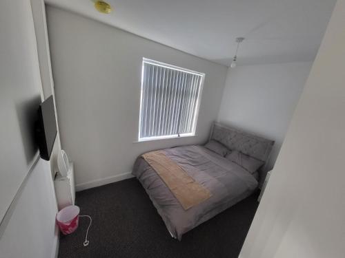 a small bedroom with a bed and a window at Hutton Lodge in Middlesbrough