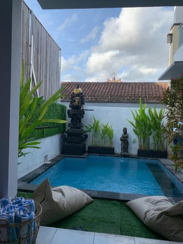 a swimming pool in the courtyard of a house at Chua Guest house Canggu in Canggu