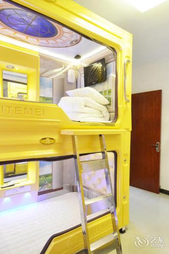 a yellow bunk bed with a ladder in a room at Hangzhou Memory Travel International Hotel-Edge Westlake in Hangzhou