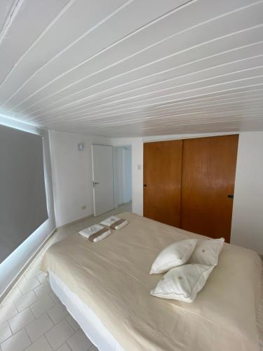 a bedroom with a large bed with two towels on it at Amelie in General Roca