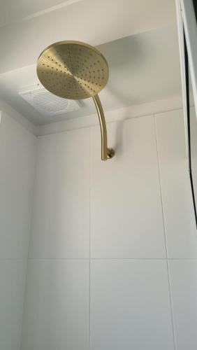 a shower head in the ceiling of a bathroom at Husky 19 Beautifully Appointed Apartments - GREAT LOCATION - in the heart of Husky in Huskisson