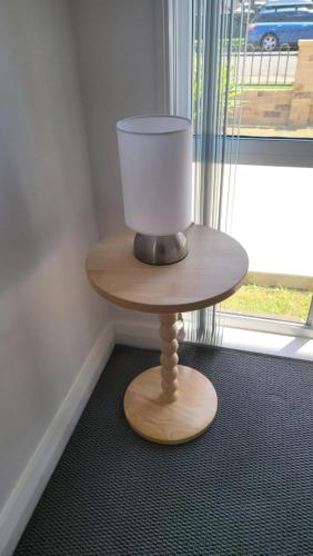 a small table with a bucket on top of it at Husky 19 Beautifully Appointed Apartments - GREAT LOCATION - in the heart of Husky in Huskisson