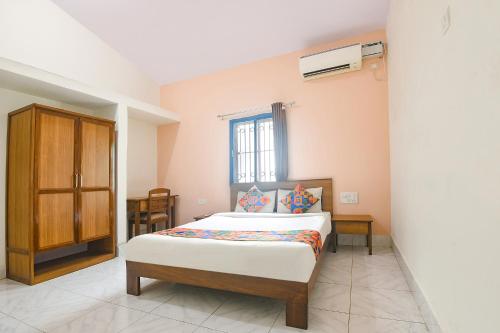 a bedroom with a bed and a window at FabExpress Joey's Place in Nerul