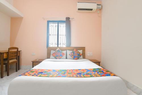 a bedroom with a large white bed with a window at FabExpress Joey's Place in Nerul