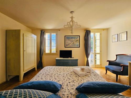 a bedroom with a bed and a television in it at La Fabbrica Delle Idee B&B in Fonte