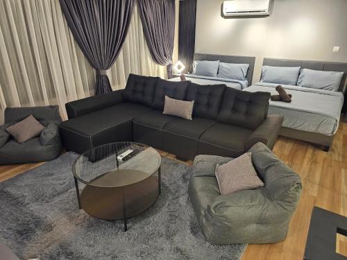 a living room with a couch and a couch and a table at Arte Cheras The Premium Suites by iLuxHome in Kuala Lumpur