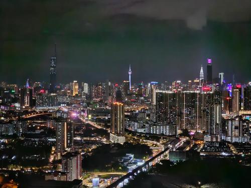 a night view of a large city with at Arte Cheras The Premium Suites by iLuxHome in Kuala Lumpur