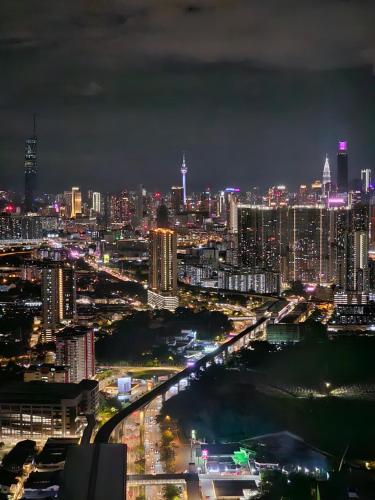 a city lit up at night with a bridge at Arte Cheras The Premium Suites by iLuxHome in Kuala Lumpur
