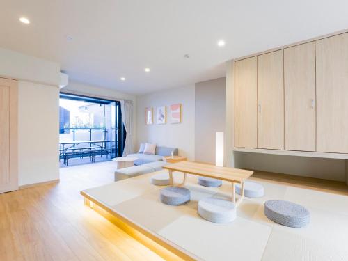 a living room with a table and a couch at Rakuten STAY Nikko Hoden in Nikko