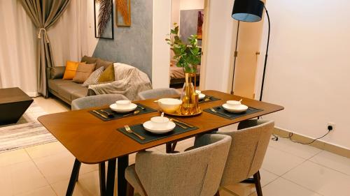 a dining room table and chairs in a living room at Kulai d'putra suites beside ioiMall near Airport and JPO in Kulai
