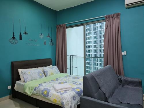 a bedroom with a bed and a chair and a window at Great Escape by SM Retreats in Cyberjaya