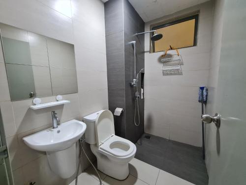 a bathroom with a toilet and a sink and a shower at Great Escape by SM Retreats in Cyberjaya