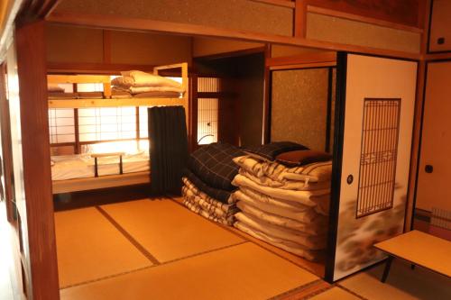 Zimmer mit 2 Etagenbetten und Handtüchern in der Unterkunft 【一棟貸し切り】海辺の静かな古民家宿『１』 in Tateishi
