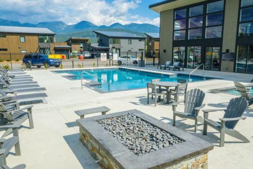 a swimming pool with chairs and a table and a table and chairs at Mountain View Chalet at The Quarry - Sleeps 6! in Whitefish