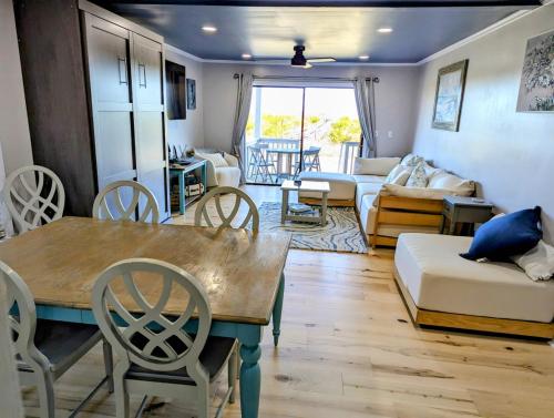 a living room with a table and chairs and a couch at Harbor Island D112 in Oceanmarsh Subdivision