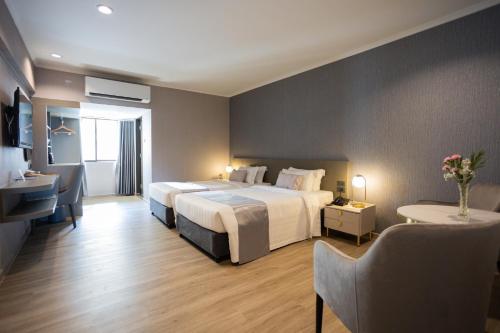 Postel nebo postele na pokoji v ubytování S.D. Avenue Hotel