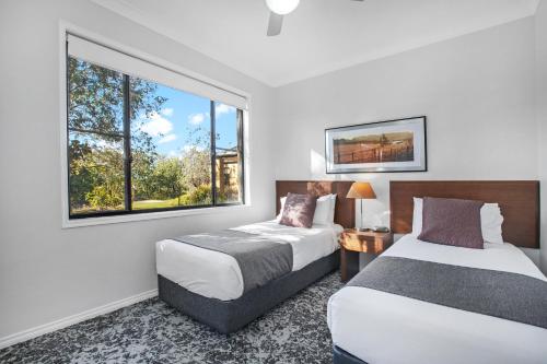 a hotel room with two beds and a window at Club Wyndham Pokolbin Hill in Pokolbin