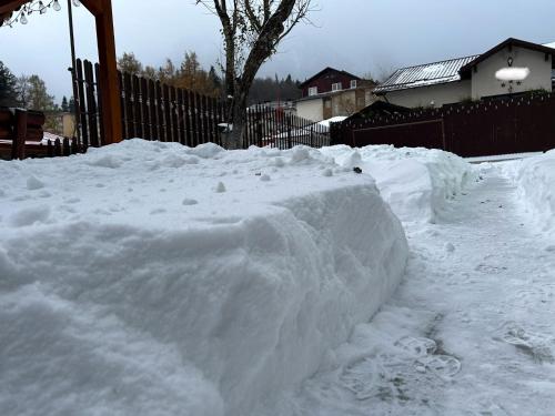 a pile of snow next to a fence at La Casa Verde in Buşteni