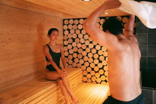 a couple of people in a sauna at 8HOTEL Chigasaki in Chigasaki