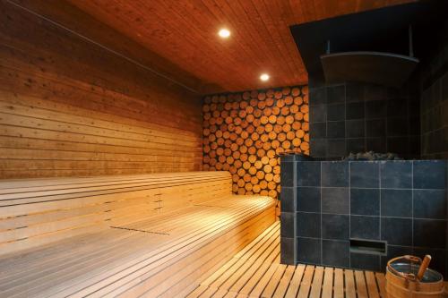 an empty sauna with a wood paneled wall at 8HOTEL Chigasaki in Chigasaki