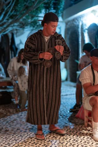 a man in a robe holding a teddy bear at Dar Afoulky Maison D'hotes in Sidi Kaouki