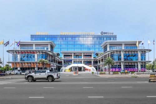 a truck parked in front of a large building at VM Hotel in Phnom Penh