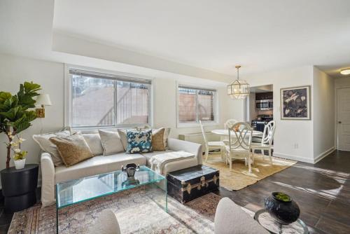 a living room with a couch and a table at Crystal City Charm Free Parking 102 in Arlington