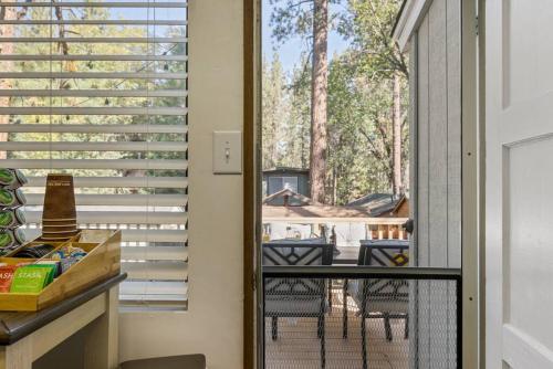 a screened in porch with a view of a yard at Storybook Cottage Near Slopes in Big Bear Lake