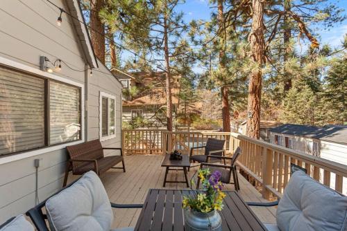 a patio with chairs and a table on a deck at Storybook Cottage Near Slopes in Big Bear Lake