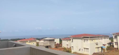 a row of houses with the ocean in the background at B-5 Sea Vista Apartment Dream Home in Ratnagiri