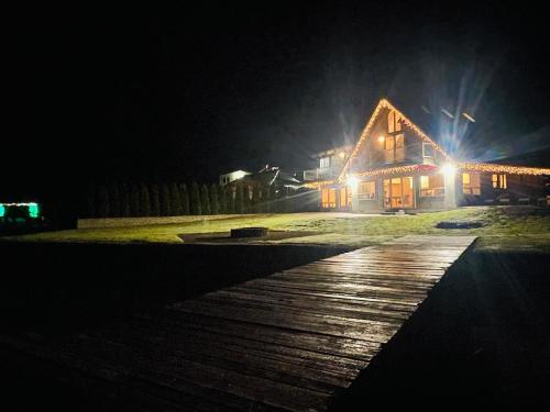 a wooden walkway in front of a house at night at Lake Tapps Dock House on the Bankers Island in Dieringer