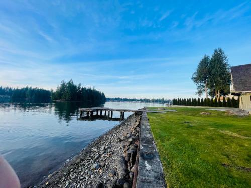 a dock in the water next to a lake at Lake Tapps Dock House on the Bankers Island in Dieringer